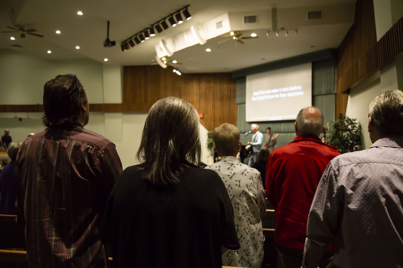The congregation standing during worship